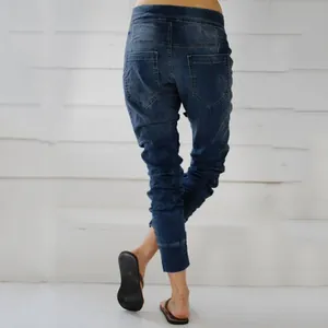 Back view detail of women's blue loose fit plus size denim joggers with elastic waist