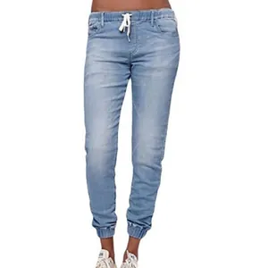 Women's light blue elastic waist denim joggers with drawstring and cuffed ankles.