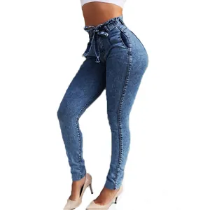 Side view showing slim-fit high-waisted paper-bag denim jeans with a matching tie-belt