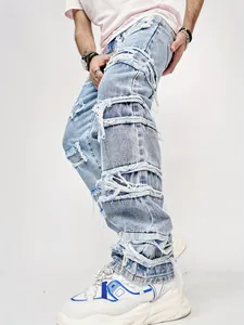 Detail shot of men's distressed denim jeans with unique frayed bands and street style