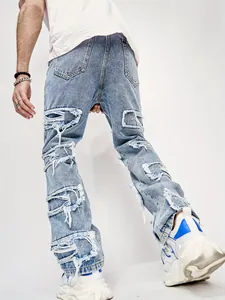 Detailed back view of men's distressed straight-leg jeans with street style frayed patches.