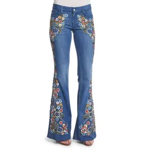 High-waisted blue flare jeans featuring intricate floral embroidery on the outer sides