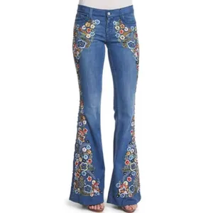 Stylish women's blue denim flare jeans featuring intricate colorful floral embroidery details