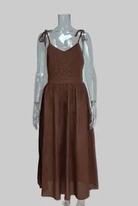Close-up of elegant brown V-neck maxi dress with spaghetti straps and high waistline