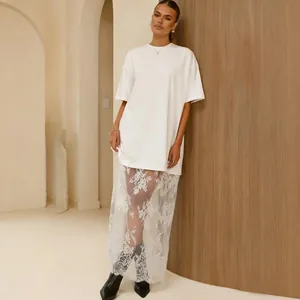 Chic oversized white t-shirt dress with elegant sheer lace patchwork detail