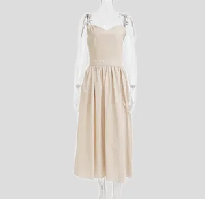 Front view of an elegant beige V-neck high-waist spaghetti strap backless midi dress