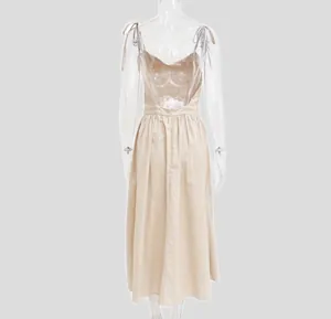 Detailed back view of an elegant beige backless midi dress with delicate spaghetti straps