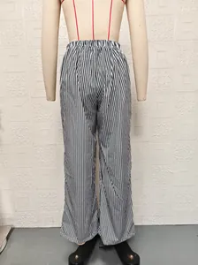 Back view of black and white vertical striped straight-leg pants on a mannequin