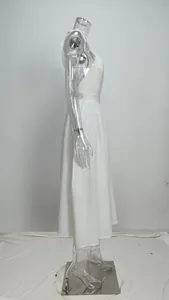 Elegant white backless V-neck maxi dress with bow straps shown on a clear mannequin.