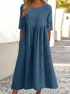 Detailed view of loose-fit blue cotton linen dress with round neck and half sleeves.