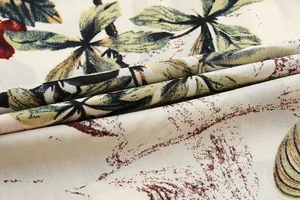 Close-up macro view of the vintage tropical leaf print on soft cotton fabric for women's jumpsuit