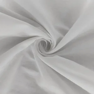 Macro detail view of soft white lightweight fabric texture for elegant summer dresses