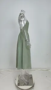 Side profile of an elegant sage green backless midi dress featuring a high waistline
