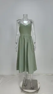 Front view of an elegant green V-neck high waist midi strap dress on a mannequin