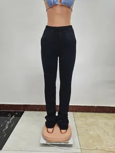Detail view of women's high waisted black stacked sweatpants with adjustable drawstring