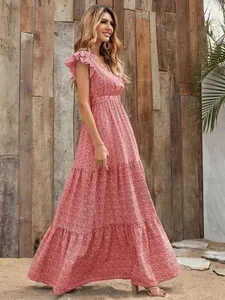 Full length side detail view of a vibrant red V-neck floral tiered maxi dress for women