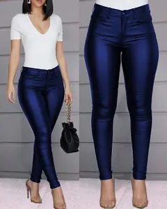 Close-up of shiny dark blue slim-fit PU leather pants for women with metallic finish