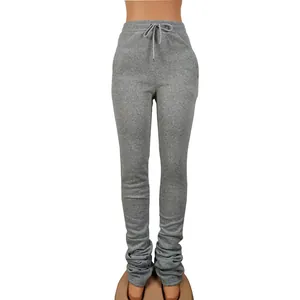 Detailed view of grey stacked joggers featuring adjustable high waist drawstring design
