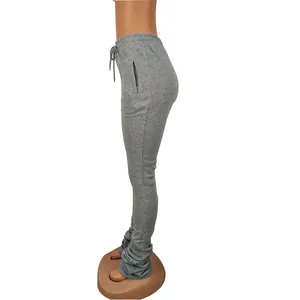 Detailed side view of women's gray high-waisted stacked sweatpants with drawstring.