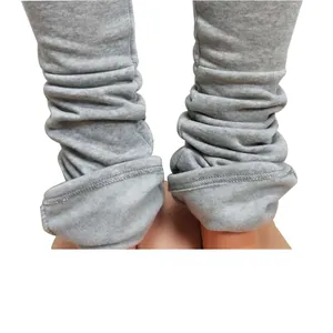 Close-up detail of grey stacked leggings showing soft fleece lining and ruched ankle