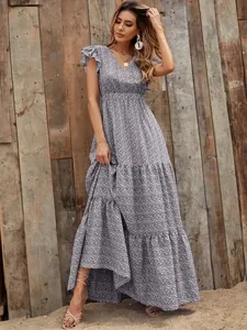 Detailed view of a V-neck high waist floral print tiered maxi dress on a model