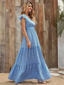 Full length side view of a blue floral print V-neck high waist layered maxi dress on a model