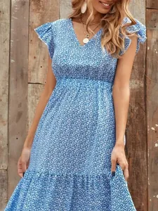 Close-up detail of blue floral V-neck tiered dress featuring ruffle sleeves and high waist