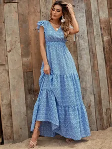 Full view of this blue V-neck floral maxi dress with layered skirt and flutter sleeves.