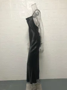 Side view of black backless fishtail slip dress on clear mannequin