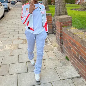 Full body view of plus size grey stacked joggers with drawstring on a model walking outdoors