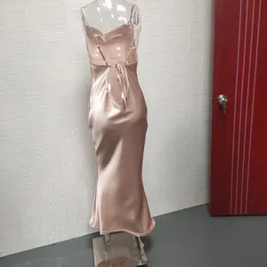 Rear view of an elegant champagne pink satin backless fishtail dress on a mannequin