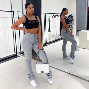 Close-up of women's grey high-waist drawstring stacked joggers worn by a model