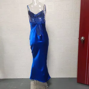 Back view of a sleek blue satin backless maxi dress with lace-up detail on mannequin