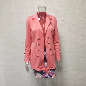 Detail view of pink double-breasted blazer and colorful geometric plaid skirt set