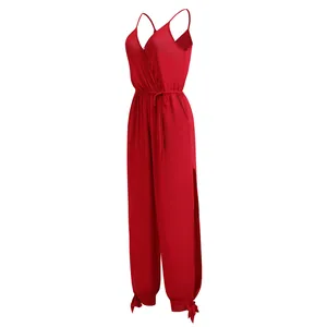 Detailed side view of a red v-neck jumpsuit featuring side slits and drawstring waist