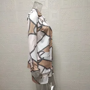 Side profile of elegant women's two-piece set featuring chain print blazer and mini skirt
