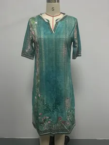 Teal ethnic print V-neck dress with floral details displayed on a mannequin dress form