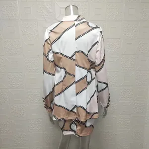 Elegant women's chain print blazer and mini skirt two-piece set shown from the back