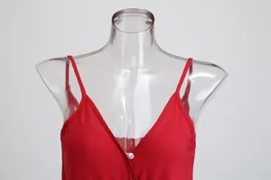 Close-up detail of a vibrant red cotton camisole jumpsuit on a transparent mannequin