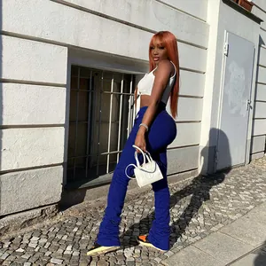 Full view of blue high waist stacked sweatpants for women in a street style setting