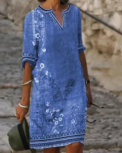 Close-up detail of blue ethnic floral print casual V-neck midi dress for women
