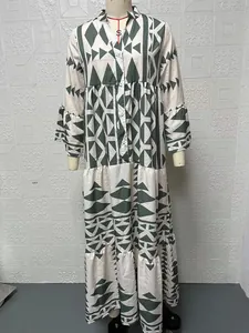 Detailed view of a bohemian tiered shirt dress featuring green geometric print and ruffles