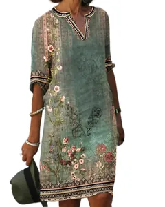 Detailed view of the bohemian floral print on a vintage teal V-neck casual midi dress