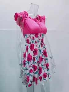 Side view detail of pink floral dress with ruffle sleeves and elastic waist