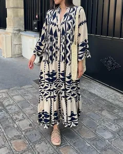 Detail view of a bohemian geometric print maxi shirt dress worn in a street setting.