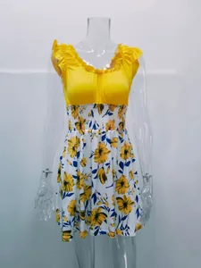 Close-up detail of yellow floral summer dress with ruffled shoulders and U-neckline