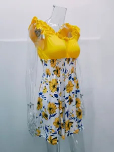 Elegant yellow floral summer dress with ruffled shoulders and U-neck on mannequin