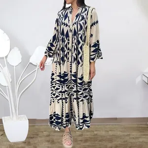 Detail view of a long bohemian shirt dress with navy geometric patterns