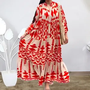 Close-up view of a Bohemian maxi dress featuring vibrant red geometric diamond patterns.