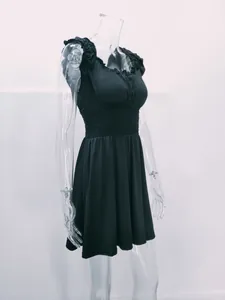 Side view of elegant black U-neck dress with smocked waist detail